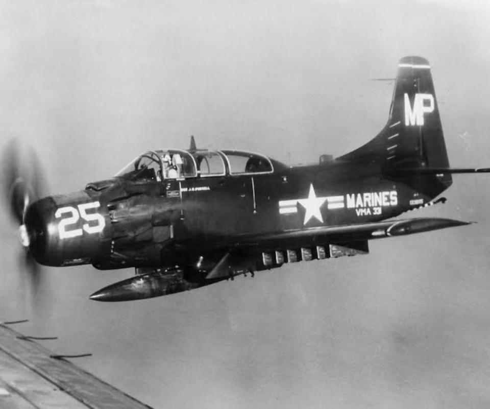 A U.S. Marine Corps AD-5 Skyraider is shown in flight.