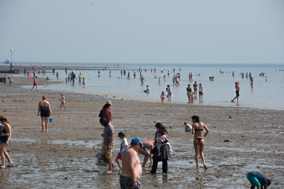 SOUTHEND-ON-SEA, ENGLAND AUGUST 11: People walk out from the beach at low tide to cool down in the water during the recent hot weather on August 11, 2020 in Southend on Sea, England. Parts of the UK remain in the grip of a Summer heatwave that has seen temperatures rise above 30 degrees in much of the country. (Photo by John Keeble/Getty Images)