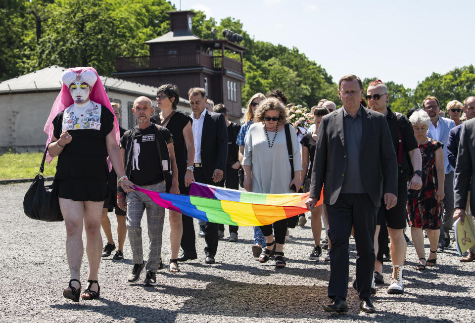 People carry a rainbow flag in remembrance for prisoners assigned a pink triangle in the former Nazi concentration camp Buchenwald within the Christopher Street Day in Weimar, Germany, Sunday, June 23, 2019. There were 650 prisoners assigned a pink triangle in the Buchenwald concentration camp between 1937 and 1945. Many of them lost their lives. (AP Photo/Jens Meyer)