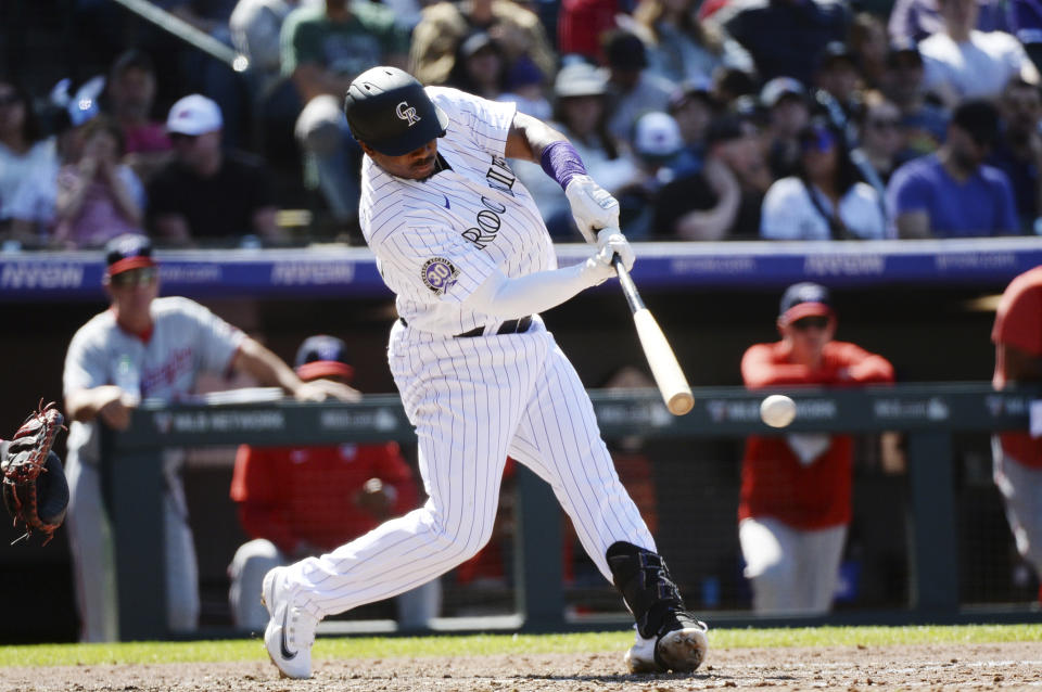 Colorado Rockies' Elehuris Montero doubles in the sixth inning of a baseball game, Sunday, April 9, 2023, in Denver. (AP Photo/Geneva Heffernan)