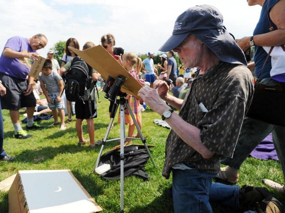 Robert Baillie adjusts the binoculars he’s using to project the eclipse Monday, Aug. 21, 2017 at The Arboretum at Penn State.