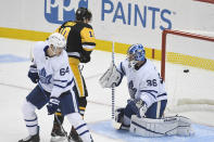 Toronto Maple Leafs' David Kampf (64) and Pittsburgh Penguins' Drew O'Connor (10) watch a puck get by Maple Leafs' Jack Campbell for a goal during the first period of an NHL hockey game Saturday, Oct. 23, 2021, in Pittsburgh, Pa. (AP Photo/Fred Vuich)