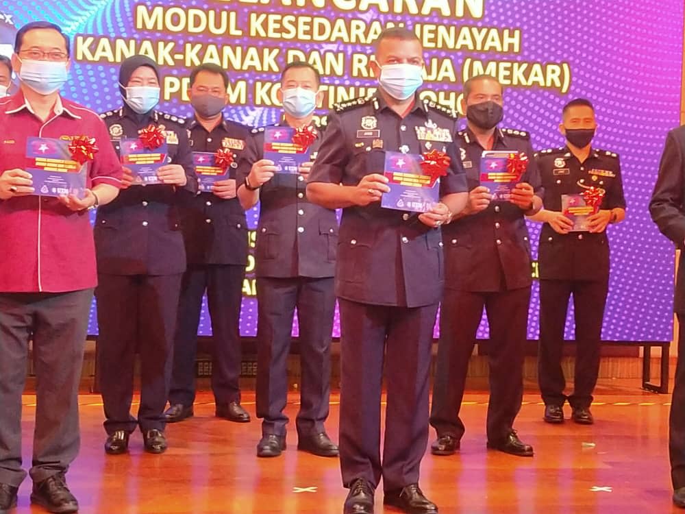 Johor police chief Datuk Ayob Khan Mydin Pitchay (front, centre) with the Children and Teenagers Crime Awareness Module which will be implemented in schools and higher learning institutes during its launch in Iskandar Puteri today. — Picture by Ben Tan