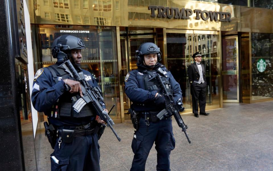 New York City Police officers guard the front of Trump Tower, in New York - AP
