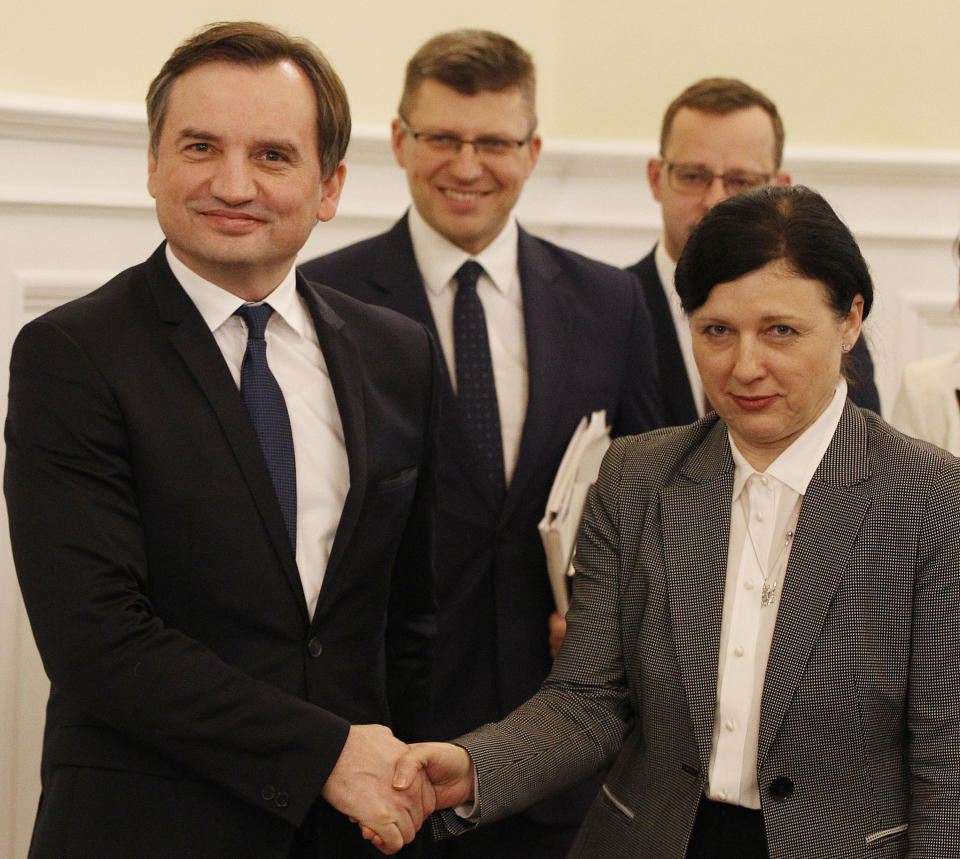 FILE - In this Jan. 28, 2020 file photo, Poland's Justice Minister Zbigniew Ziobro, left, welcomes vice president of the European Commission Vera Jourova, for talks on the conflict over the government's much-criticized taking of steps to control the judiciary in Warsaw, Poland. An official with Poland's conservative governing party, which has been governing with the support of two small parties, one led by the justice minister Ziobro, said Friday, Sept. 18, 2020, that the the country's right-wing coalition government has collapsed. (AP Photo/Czarek Sokolowski, file)