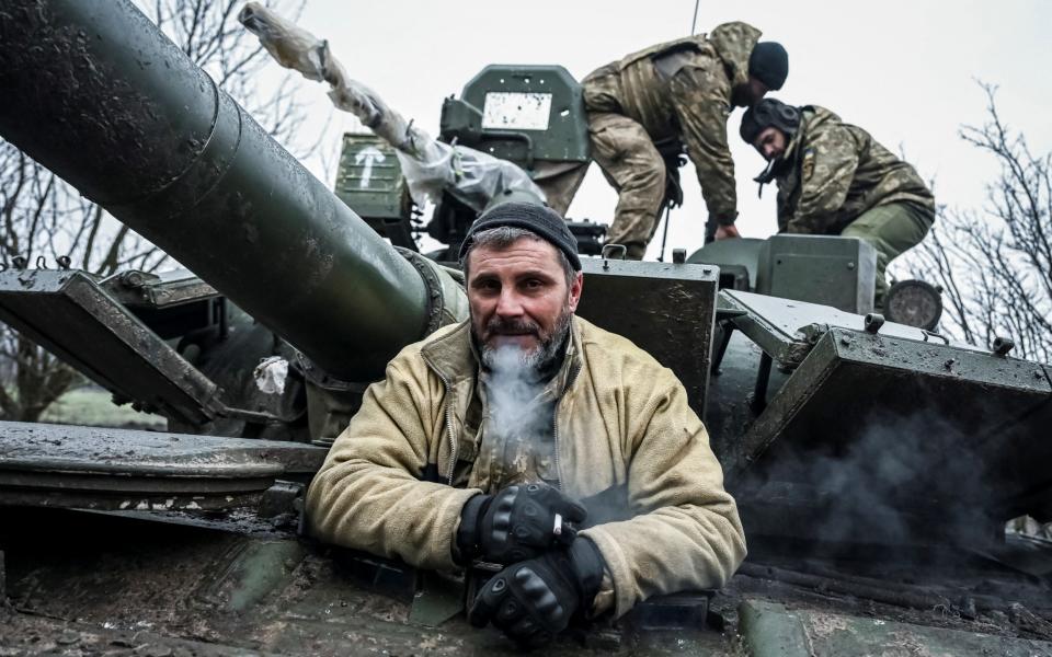 Servicemen of the Carpathian Sich Battalion are seen on a tank on a frontline - REUTERS/Viacheslav Ratynskyi