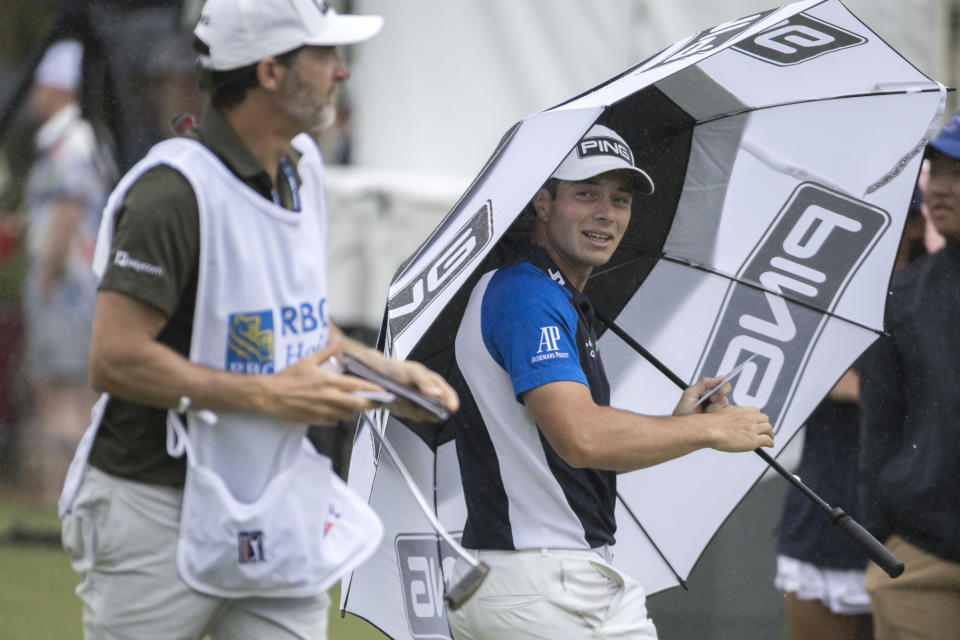 Viktor Holland, right, of Norway, walks off the ninth green after finishing the first round of the RBC Heritage golf tournament, Thursday, April 13, 2023, in Hilton Head Island, S.C. (AP Photo/Stephen B. Morton)