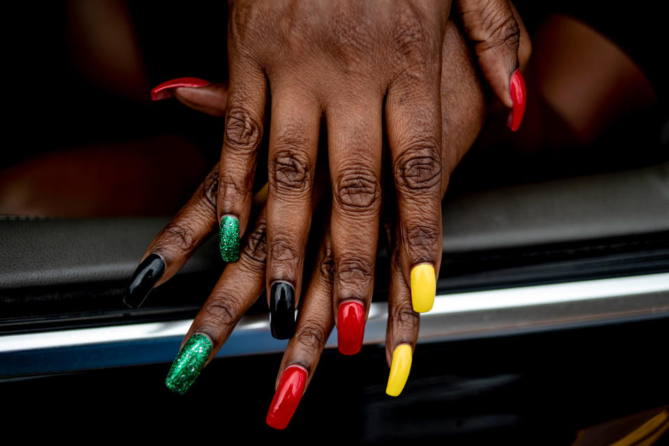 Flint resident Tracy Palmer shows off her Juneteenth-inspired nails (Jake May / MLive.com / AP)