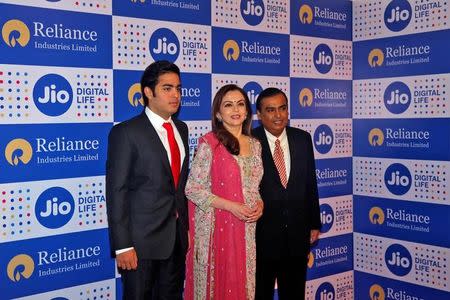 Mukesh Ambani (R), chairman of Reliance Industries Ltd, poses with his wife Nita (C) and son Akash before addressing the company's annual general meeting in Mumbai, India September 1, 2016. REUTERS/Shailesh Andrade