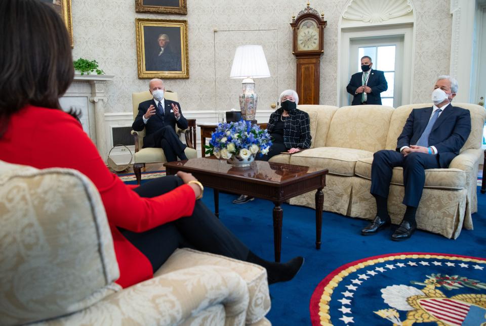 US President Joe Biden sits alongside US Treasury Secretary Janet Yellen (C) as he holds a meeting with business leaders, including Jamie Dimon (R), Chairman and CEO of JPMorgan Chase, about a Covid-19 relief bill in the Oval Office of the White House in Washington, DC, February 9, 2021. (Photo by SAUL LOEB / AFP) (Photo by SAUL LOEB/AFP via Getty Images)