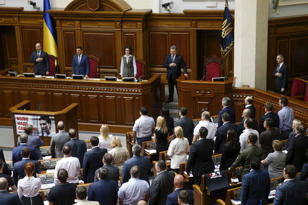 Ukrainian President Petro Poroshenko (back row, 2nd R) and members of parliament listen to the state anthem during a session in Kiev, Ukraine, July 16, 2015. REUTERS/Valentyn Ogirenko