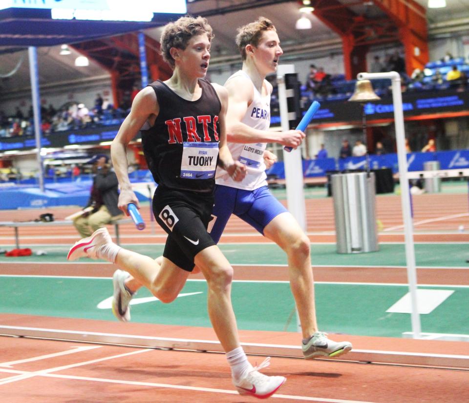 North Rockland's Ryan Tuohy and Pearl River's Jayden Lloyd McKenna run beside each other during the boys 4xmile relay at Nike Indoor Nationals March 9, 2024 at The Armory.