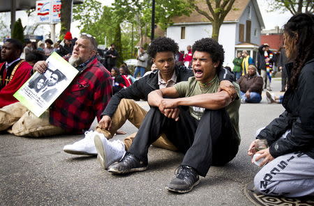 Jordan King, right, chants while blocking traffic along Williamson Street after a prosecutor said that a police officer will not face charges in the fatal shooting of an unarmed 19-year-old biracial man, in Madison, Wisconsin May 12, 2015. REUTERS/Ben Brewer