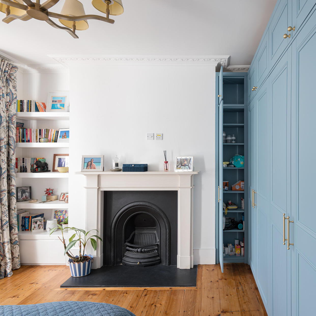  Bedroom with blue fitted wardrobes and fireplace. 