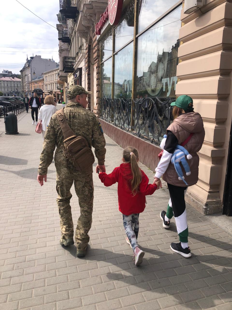 A Ukranian soldier walks with his wife and daughter in Lviv, Ukraine in May 2023. Jim Gamache, of Miromar Lakes, Florida, has offered aid in Ukraine twice since the way with Russia began in 2022. "This picture moves me every time I look at it," he says. Martial law dictates that nen between 18 and 60 are required to stay and fight in the war.