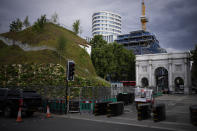 The newly built "Marble Arch Mound" after it was opened to the public next to Marble Arch in London, Tuesday, July 27, 2021. The temporary installation commissioned by Westminster Council and designed by architects MVRDV has been opened as a visitor attraction to try and entice shoppers back to the adjacent Oxford Street after the coronavirus lockdowns. (AP Photo/Matt Dunham)