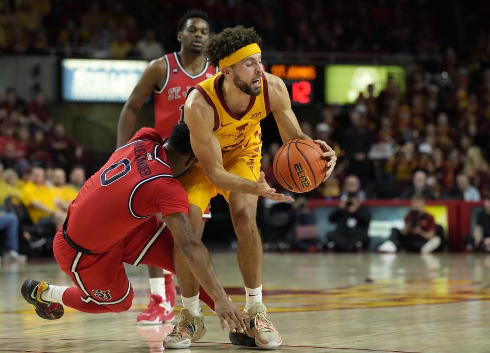St. John's guard Posh Alexander (0) and Iowa State guard Gabe Kalscheur (22) collide during the first half of an NCAA college basketball game, Sunday, Dec. 4, 2022, in Ames, Iowa. (AP Photo/ Matthew Putney)