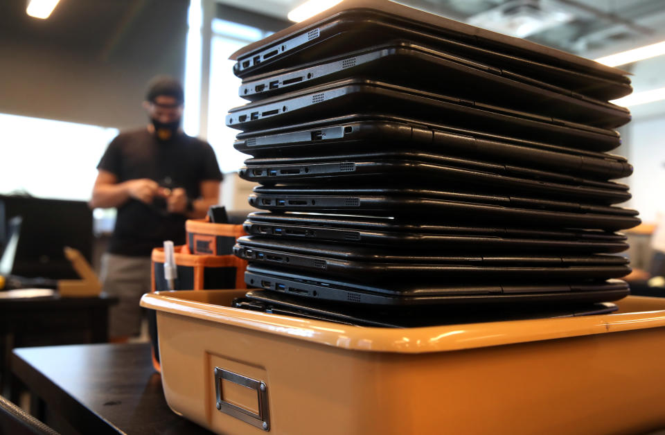 BOSTON, MA - AUGUST 21: Technology manager Juan DeJesus prepares Chromebook for students in the technology department at Boston Preparatory Charter School in Boston, MA on August 21, 2020. Boston's independently run charter schools are planning to start the school year remotely, although most intend to offer in-person learning for small groups of high needs students.  (Photo by Craig F. Walker/The Boston Globe via Getty Images)