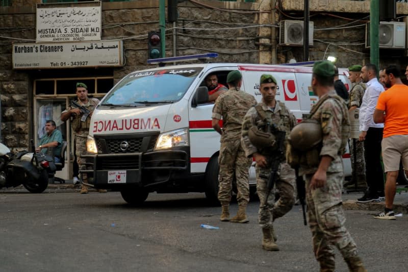 Lebanese army soldiers secure the area for an ambulance to enter the premises of the American University hospital. Eight people have been killed and some 2,750 injured in suspected coordinated explosions of hand-held telecommunications devices across Lebanon, Health Minister Firas Abiad said during a press conference in Beirut on 17 September. Marwan Naamani/dpa