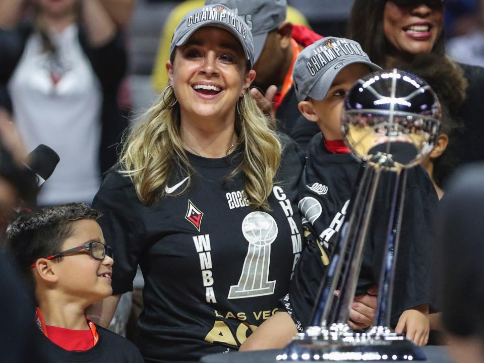 Becky Hammon and her sons pose with the WNBA championship trophy.