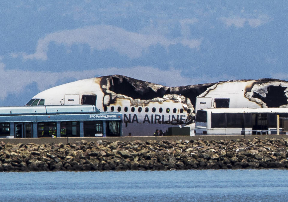 SAN FRANCISCO, CA - JULY 6:  The remains of a  Boeing 777 airplane sits on a tarmac after having crashed while landing at San Francisco International Airport July 6, 2013 in San Francisco, California. A passenger aircraft from Asiana Airlines coming from Seoul, South Korea crashed landed while on it's decent. No word so far on injuries or deaths. (Photo by Kimberly White/Getty Images)