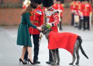 <p>Kate Middleton presents shamrocks to the Irish Guards on St. Patrick's Day—including one canine assistant.</p>