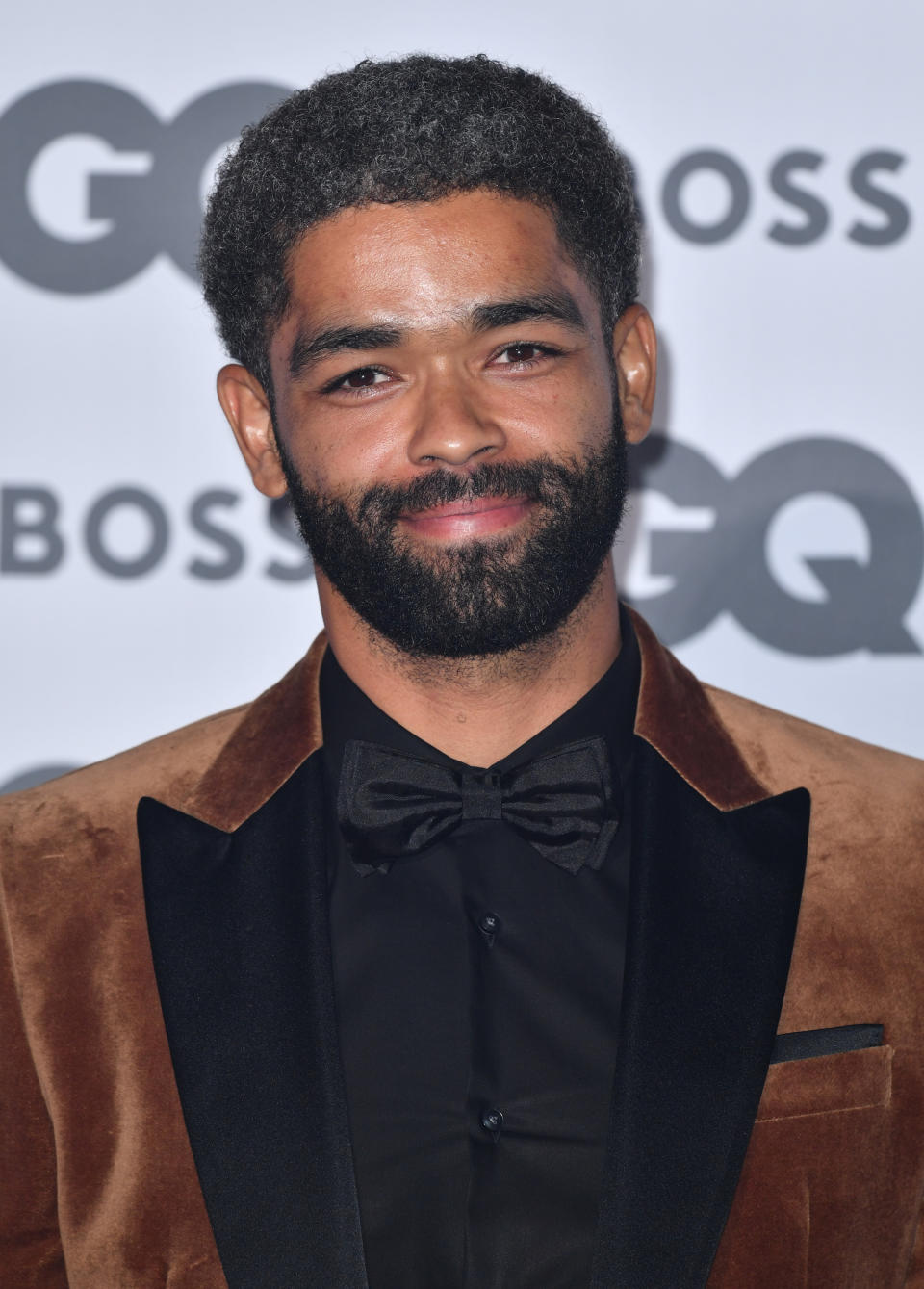 close up of a smiling Ben-Adir with facial hair