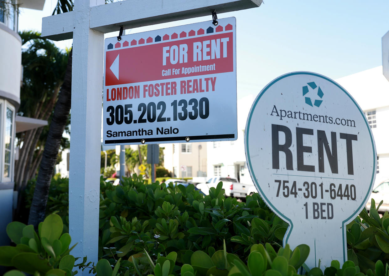 Two For Rent signs in front of a building advertise the rental company and agent and a one-bedroom apartment.