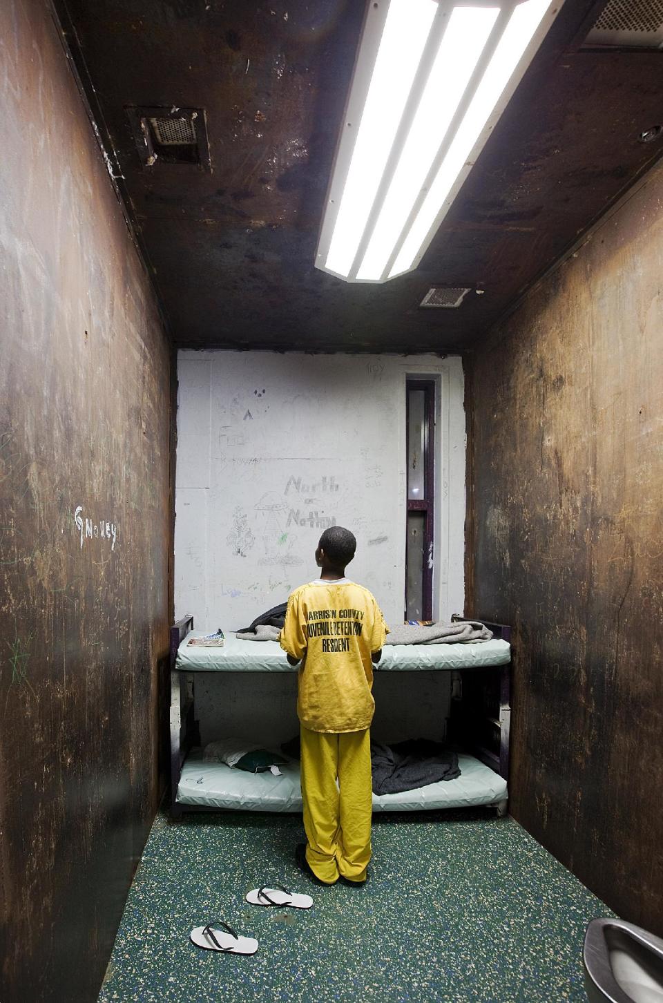 In this 2009 photo released by photographer Richard Ross, a male juvenile stands in a room at Harrison County Juvenile Detention Center in Biloxi, Miss. The stark images are part of a haunting exhibit, "Juvenile In Justice,’’ that creator Richard Ross hopes will bring changes in the way the nation deals with the approximately 70,000 youths held in detention or correctional facilities across the country on any given night _ many of them for offenses no more serious than skipping school. (AP Photo/Richard Ross)