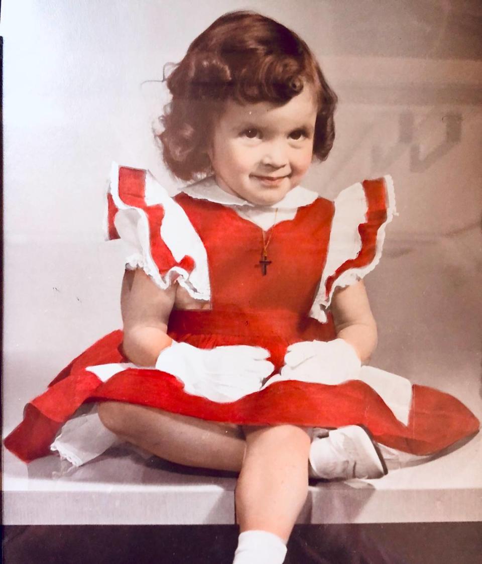 A young Suzanne O’Malley sits on a Formica table in her parents’ kitchen in Kansas City. Courtesy of Suzanne O'Malley