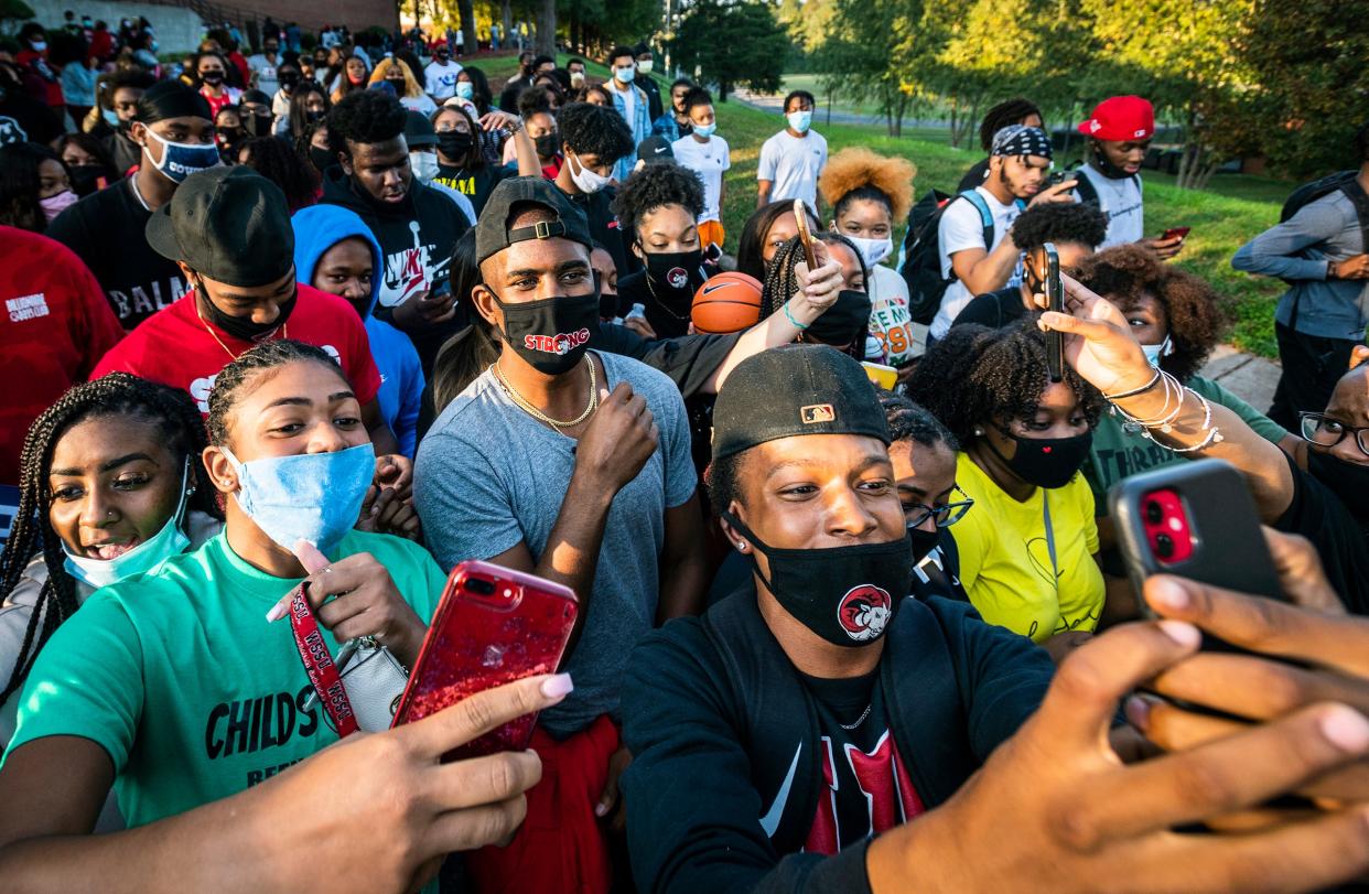 <p>NBA star and current Winston-Salem State University student Chris Paul takes selfies with his fellow Rams as he leads a march to the early voting location on campus on Tuesday, Oct. 27, 2020, in Winston-Salem, North Carolina.</p> (Andrew Dye/The Winston-Salem Journal via AP)