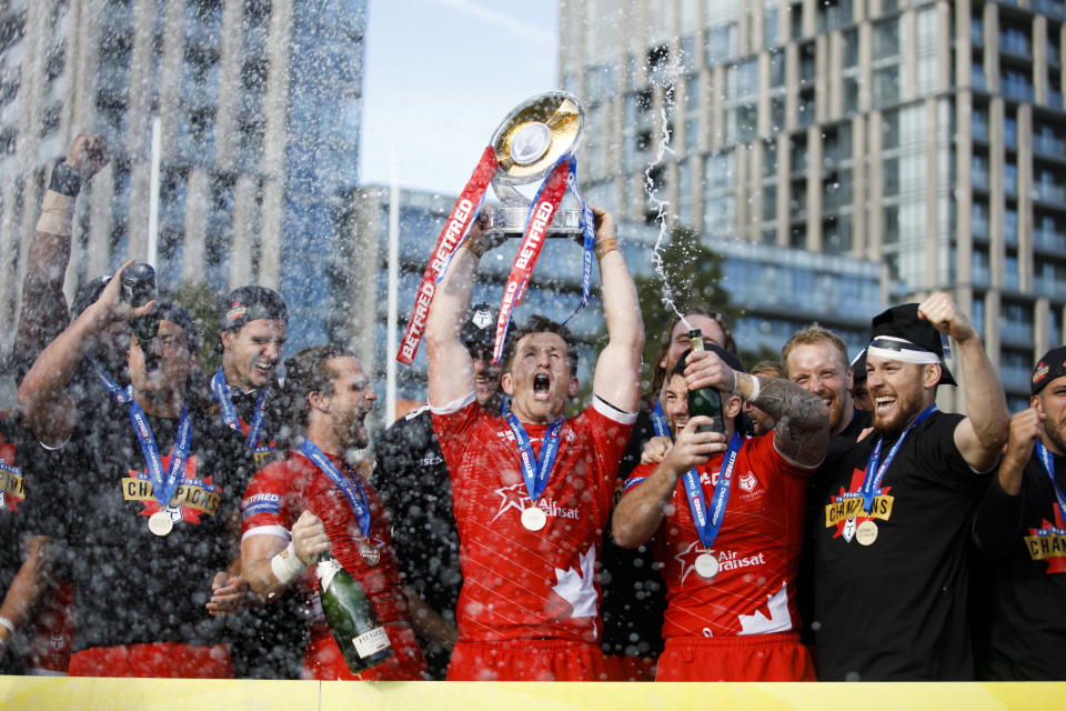 Toronto Wolfpack captain Josh McCrone raises the trophy alongside teammates after defeating the Featherstone Rovers in the Million Pound Game in a Betfred Championship rugby play-off game in Toronto, Saturday, Oct. 5, 2019. (Cole Burston/The Canadian Press via AP)