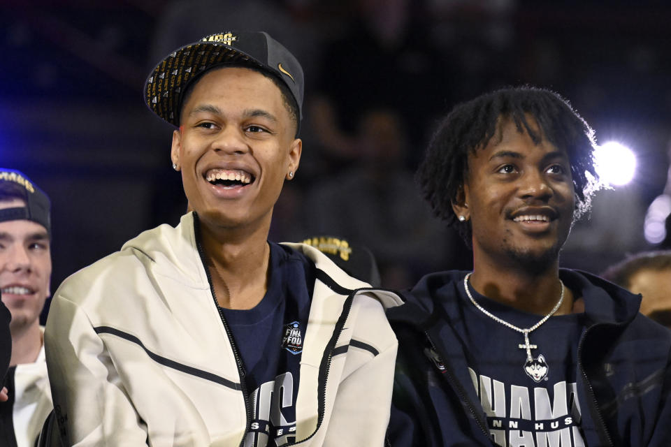 UConn's Jordan Hawkins, left, and Tristen Newton smile as they watch game highlights during a rally at Gampel Pavilion celebrating UConn's NCAA men's Division I basketball championship, Tuesday, April 4, 2023, in Storrs, Conn. (AP Photo/Jessica Hill)