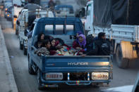 Kurdish civilians sit at the back of a truck in Afrin, Syria March 18, 2018. REUTERS/Khalil Ashawi