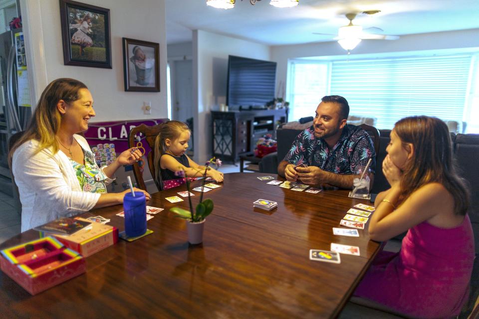 From left: Chae Logan MacLea, Clara, DC MaLlea and Isla playing a board game at their home in Palm Beach Gardens, Florida, on Friday June 9, 2023. | Saul Martinez, for the Deseret News
