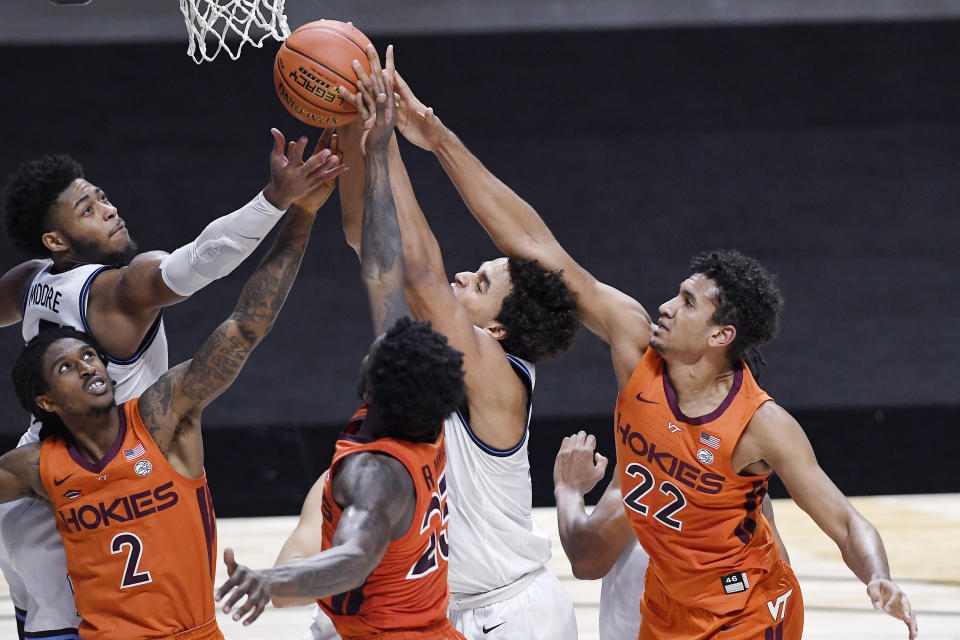 Virginia Tech and Villanova players vie for a rebound in the second half of an NCAA college basketball game, Saturday, Nov. 28, 2020, in Uncasville, Conn. (AP Photo/Jessica Hill)