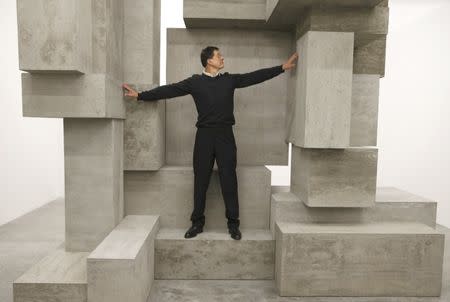 Artist Antony Gormley poses for a photograph with one of his pieces called "Block", forming part of an exhibition entitled "Fit", at the White Cube gallery in London, Britain September 29, 2016. REUTERS/Peter Nicholls