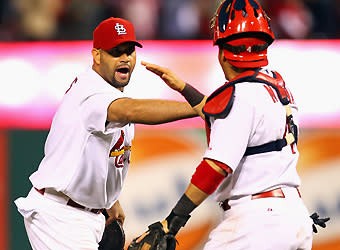 Albert Pujols (left) and Yadier Molina react to the Cardinals' 4-3 victory in Game 3 of the NLCS. St. Louis took a 2-1 series lead