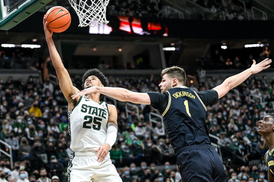 Michigan State's Malik Hall, left, shoots as Michigan's Hunter Dickinson defends during the first half on Saturday, Jan. 29, 2022, at the Breslin Center in East Lansing.