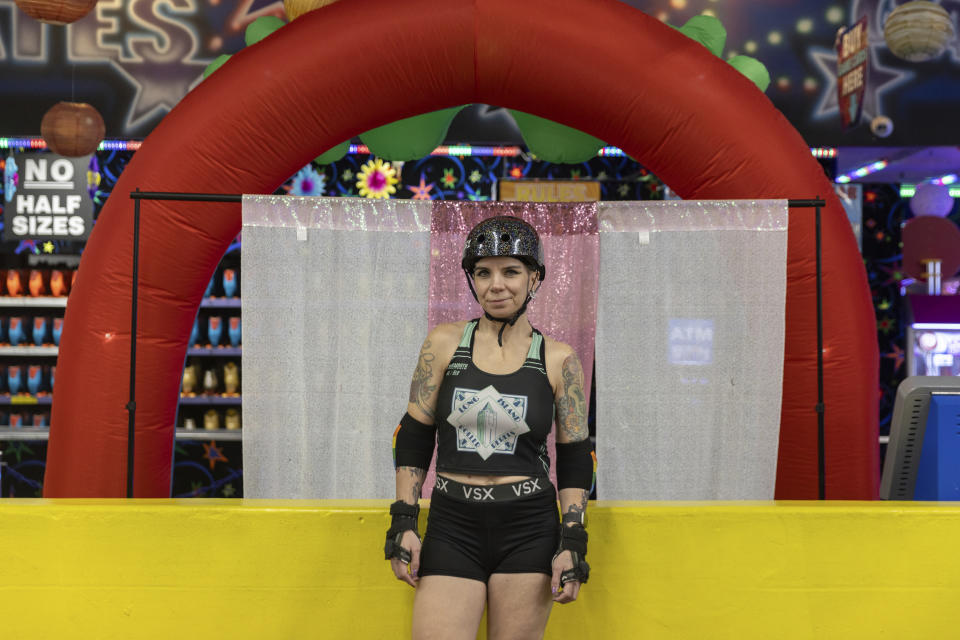 Caitlin Carroll, one of members of the Long Island Roller Rebels, stands for a photograph, Tuesday, March 19, 2023, at United Skates of America in Seaford, N.Y. (AP Photo/Jeenah Moon)