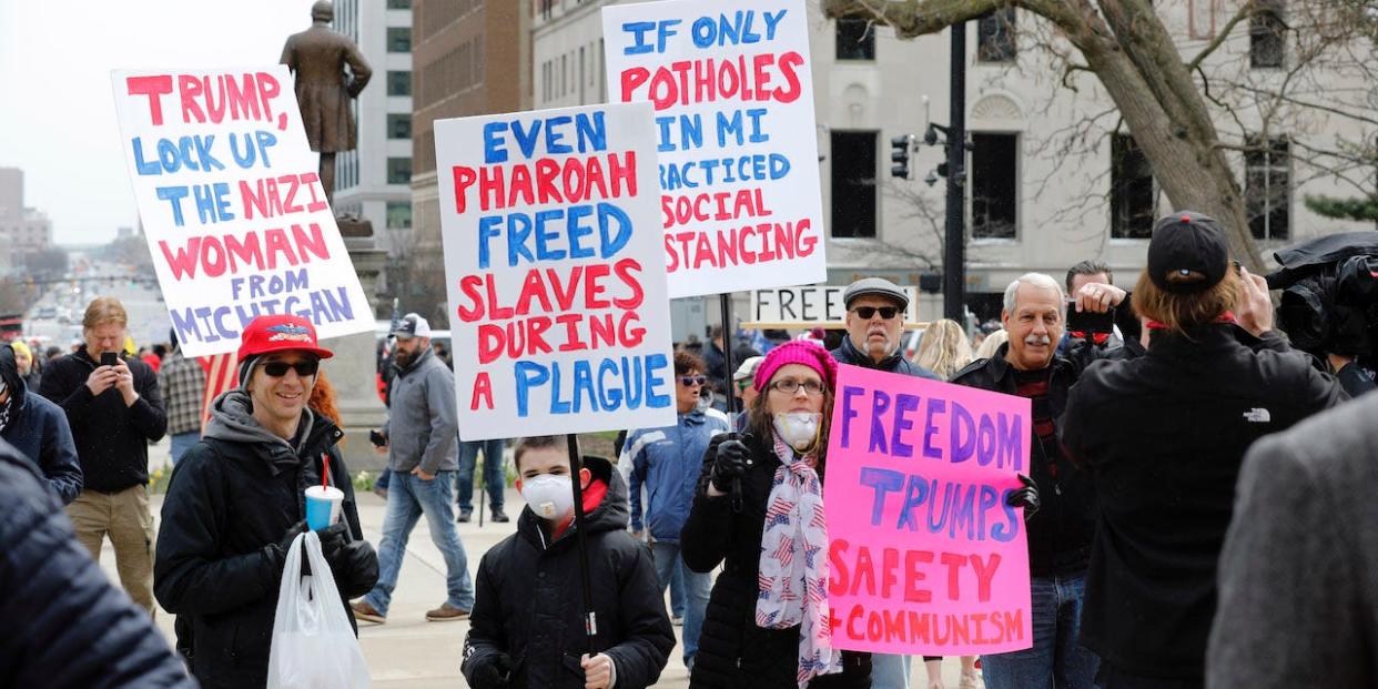 People protest against excessive quarantine amid the coronavirus pandemic at the Michigan State Capitol in Lansing, Michigan on April 15, 2020.