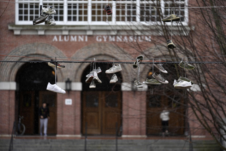 Sneakers hang on utility lines near Alumni Gymnasium on the campus of Dartmouth College, Tuesday, March 5, 2024, in Hanover, N.H. Dartmouth basketball players voted to form a union, an unprecedented step in the continued deterioration of the NCAA's amateur business model. (AP Photo/Robert F. Bukaty)