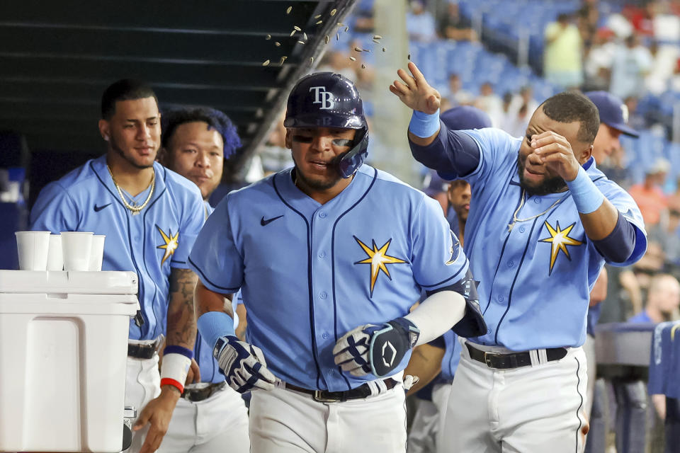 Tampa Bay Rays' Isaac Paredes, center, is congratulated after his home run against the Los Angeles Angels during the sixth inning of a baseball game Tuesday, Aug. 23, 2022, in St. Petersburg, Fla. (AP Photo/Mike Carlson)