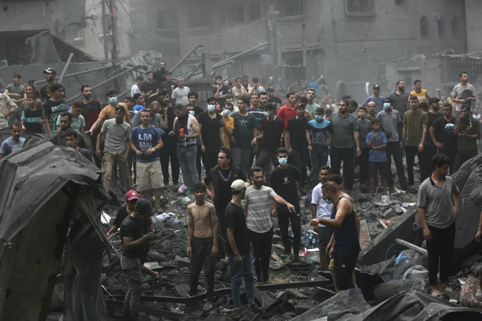 Palestinians inspect the damage of destroyed buildings following Israeli airstrikes on Gaza City, Friday, Oct. 27, 2023. (AP Photo/Abed Khaled)