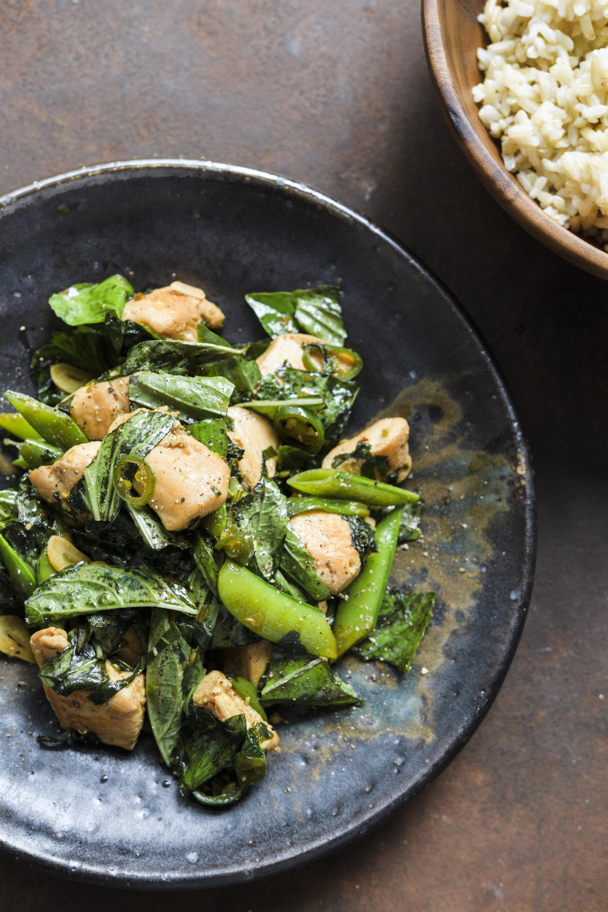This image released by Milk Street shows a recipe for Stir-Fried Chicken w/Snap Peas & Basil. (Milk Street via AP)