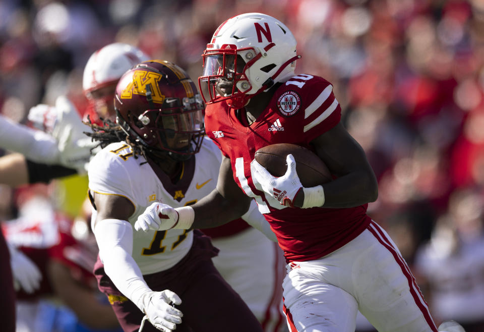 Nebraska's Anthony Grant (10) carries the ball as Minnesota's Michael Dixon (11) chases during the second half of an NCAA college football game Saturday, Nov. 5, 2022, in Lincoln, Neb. (AP Photo/Rebecca S. Gratz)