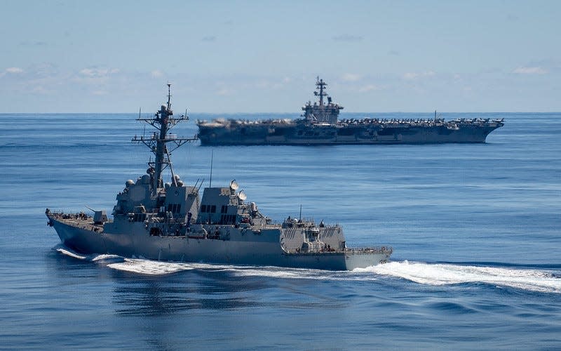 Arleigh Burke-class guided-missile destroyer USS Dewey (DDG 105), front, and Nimitz-class aircraft carrier USS Carl Vinson (CVN 70) transit the Pacific Ocean