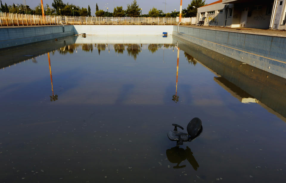 A chair stands in a deserted swimming pool at the Olympic Village in the town of Thrakomakedones, north of Athens,&nbsp;in July&nbsp;2014.