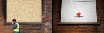 LONDON, ENGLAND - JULY 23: In this composite image (Left Photo) A man walks past a boarded up building following the riots on August 16, 2011 in Tottenham, London. (Right Photo) Graffiti on the same boarded up building, one year on from the riots. August 6th marks the one year anniversary of the England riots, over the course of four days several London boroughs, and districts of cities and towns around England suffered widespread rioting, looting and arson as thousands took to the streets. (Peter Macdiarmid/Getty Images)