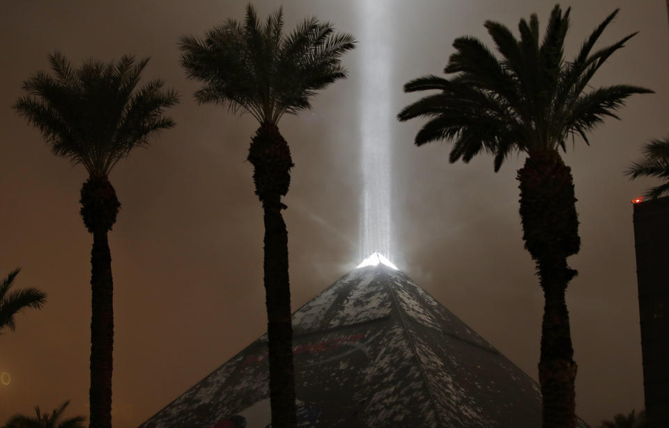 Snow falls on the Luxor hotel and casino Wednesday, Feb. 20, 2019, in Las Vegas. A winter storm is expected to drop up to 3 inches (8 centimeters) of snow on Las Vegas' southern and western outskirts while other parts of the metro area will get rain mixed with snow. (AP Photo/John Locher)